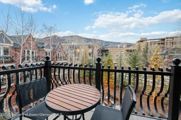 a view of a balcony with an outdoor seating
