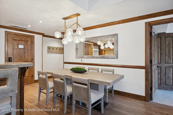 a view of a dining room with furniture and wooden floor