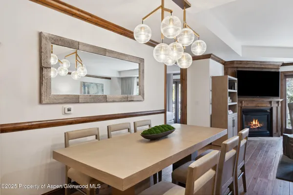 a view of a dining room with furniture wooden floor and chandelier