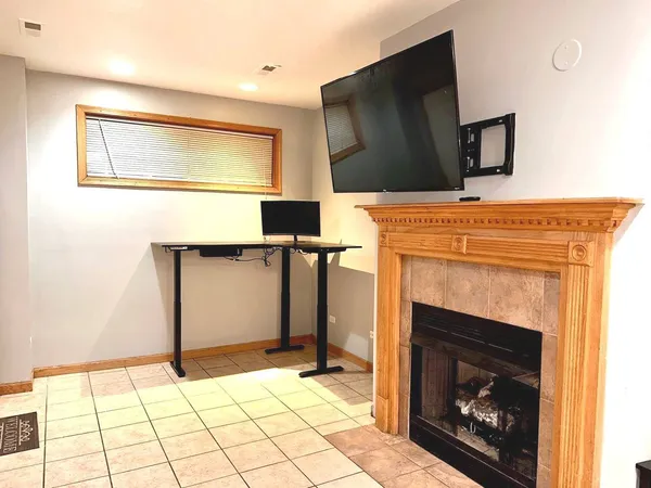 a living room with a fireplace and a flat screen tv