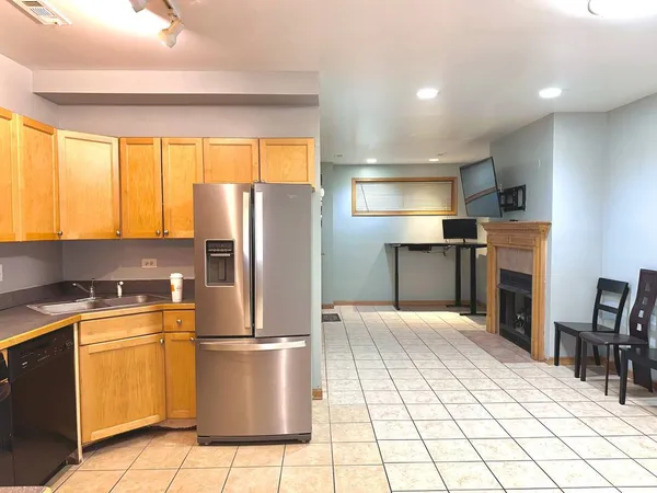 a kitchen with stainless steel appliances a refrigerator sink and cabinets