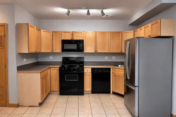 a kitchen with stainless steel appliances granite countertop a refrigerator stove and sink