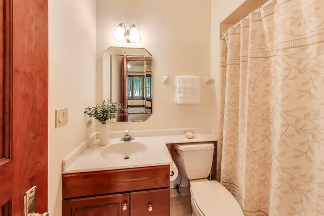 a bathroom with a sink a bathtub and next to a window