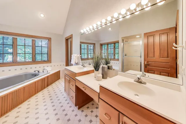 a bathroom with a bathtub and a window