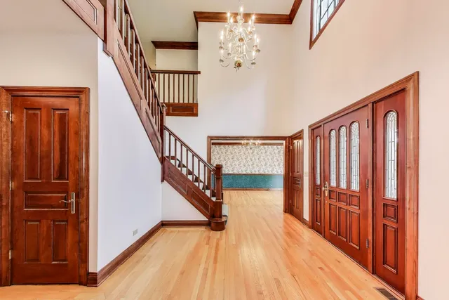 a view of front door with wooden floor and stairs