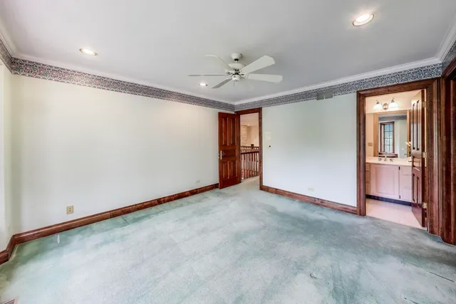 a livingroom with a large window and a rug