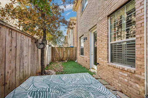 a view of a sign board with yard and trees