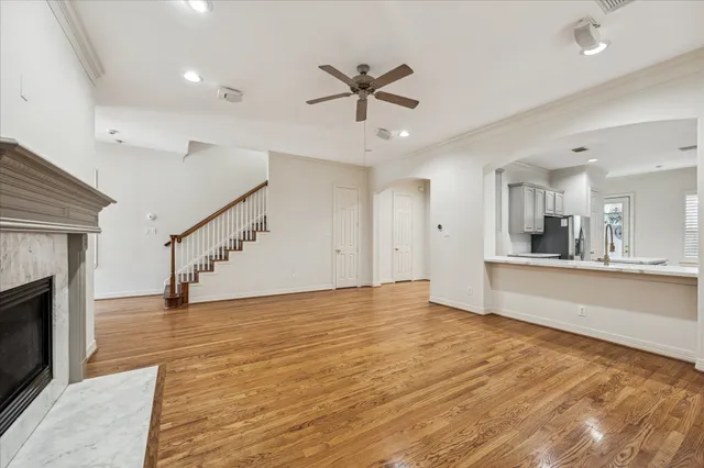 a view of empty room with wooden floor and fireplace