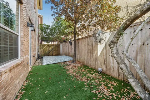 a view of a back yard with a wooden fence