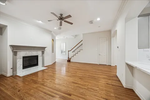 a view of empty room with wooden floor and fireplace