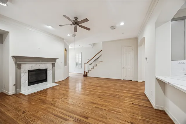a view of empty room with wooden floor and fireplace