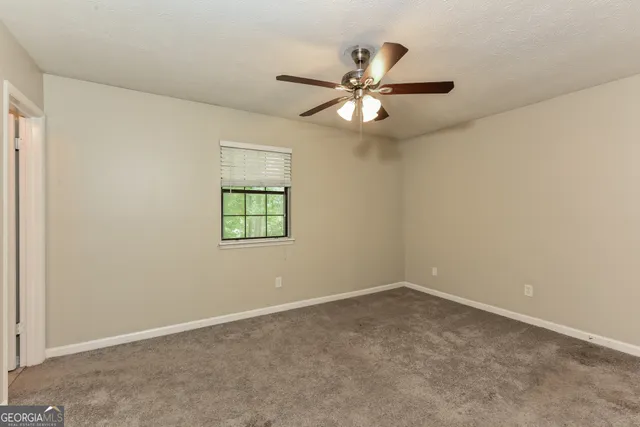 a bathroom with a granite countertop sink a toilet and shower