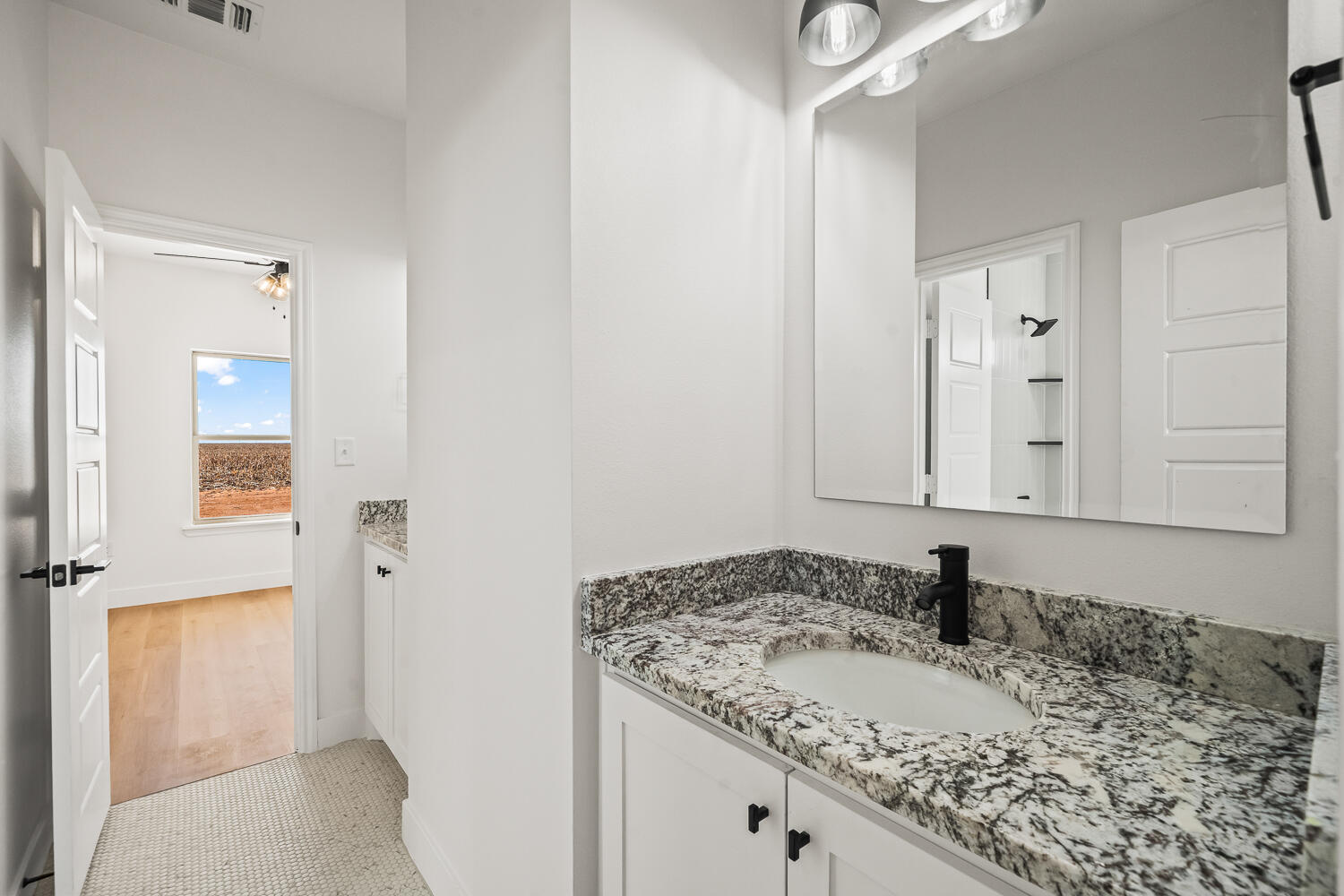 4062 Hawk Road Ropesville, TX 79358 - Photo 27 of 45 a bathroom with a granite countertop sink and a mirror