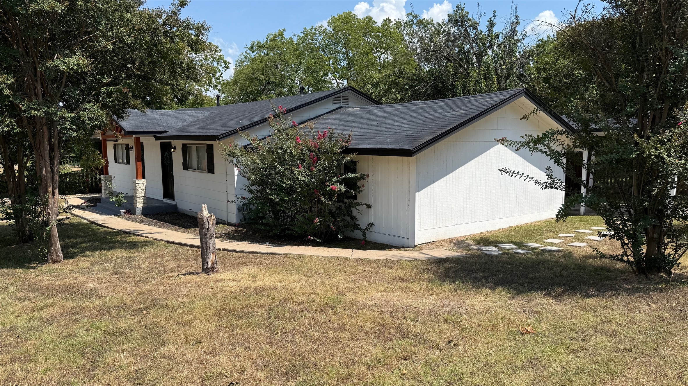 1802 East University Avenue, Unit A Georgetown, TX 78626 - Photo 2 of 23 View of home's exterior with a lawn and roof with shingles
