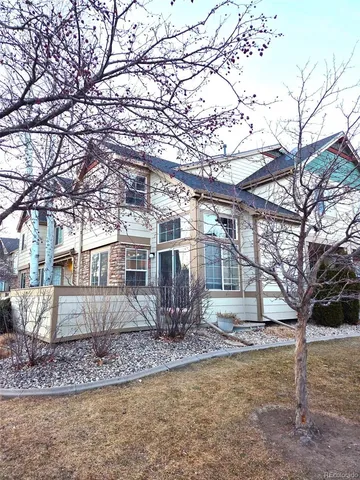 a front view of a house with yard covered in snow