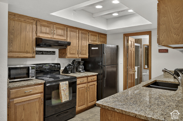 150 Ridgeview Street Brian Head, UT 84719 - Photo 9 of 43 Kitchen featuring wood-finish cabinetry, granite-style countertops, and a full suite of black appliances