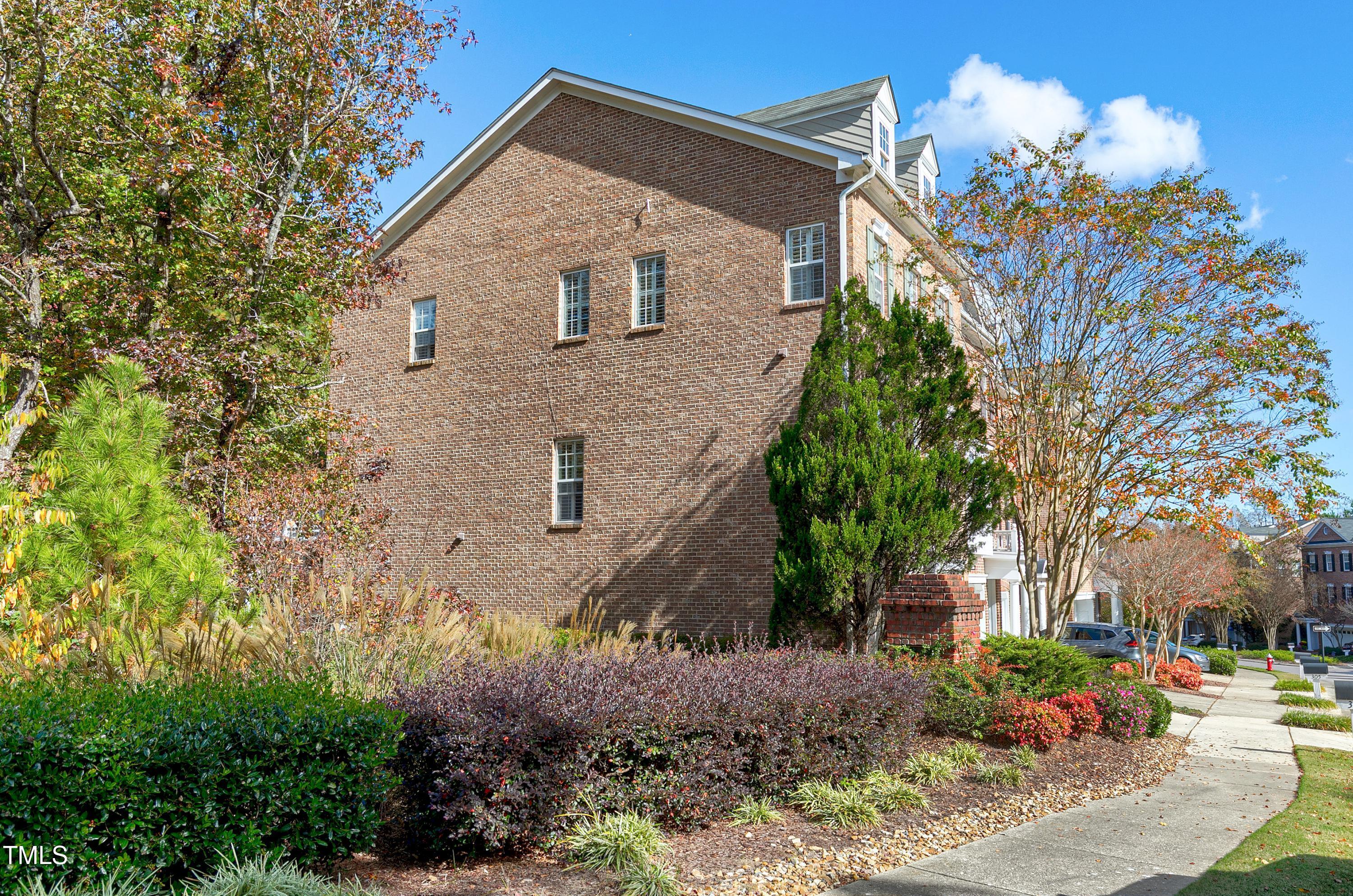 303 Bridgegate Drive Cary, NC 27519 - Photo 15 of 25 a front view of a house with garden