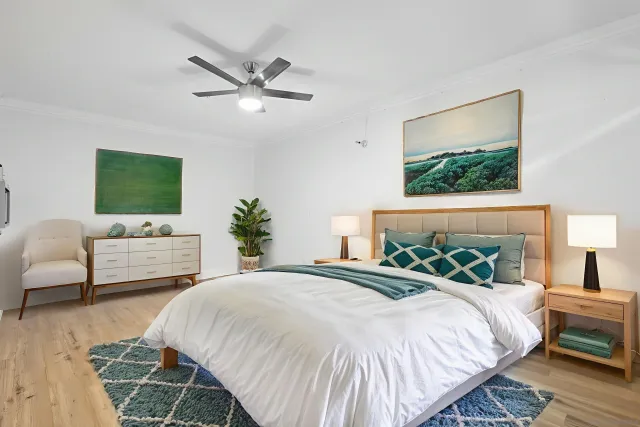 a bedroom with a large bed and a couch