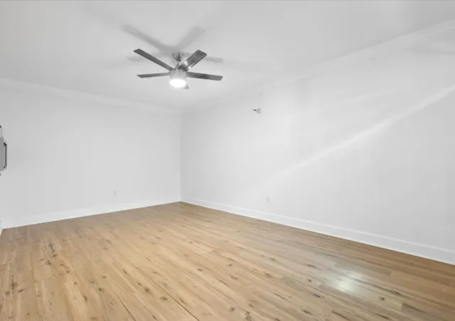 a view of an empty room and wooden floor