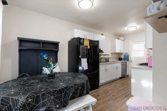 a kitchen with stainless steel appliances kitchen island granite countertop a refrigerator stove and sink