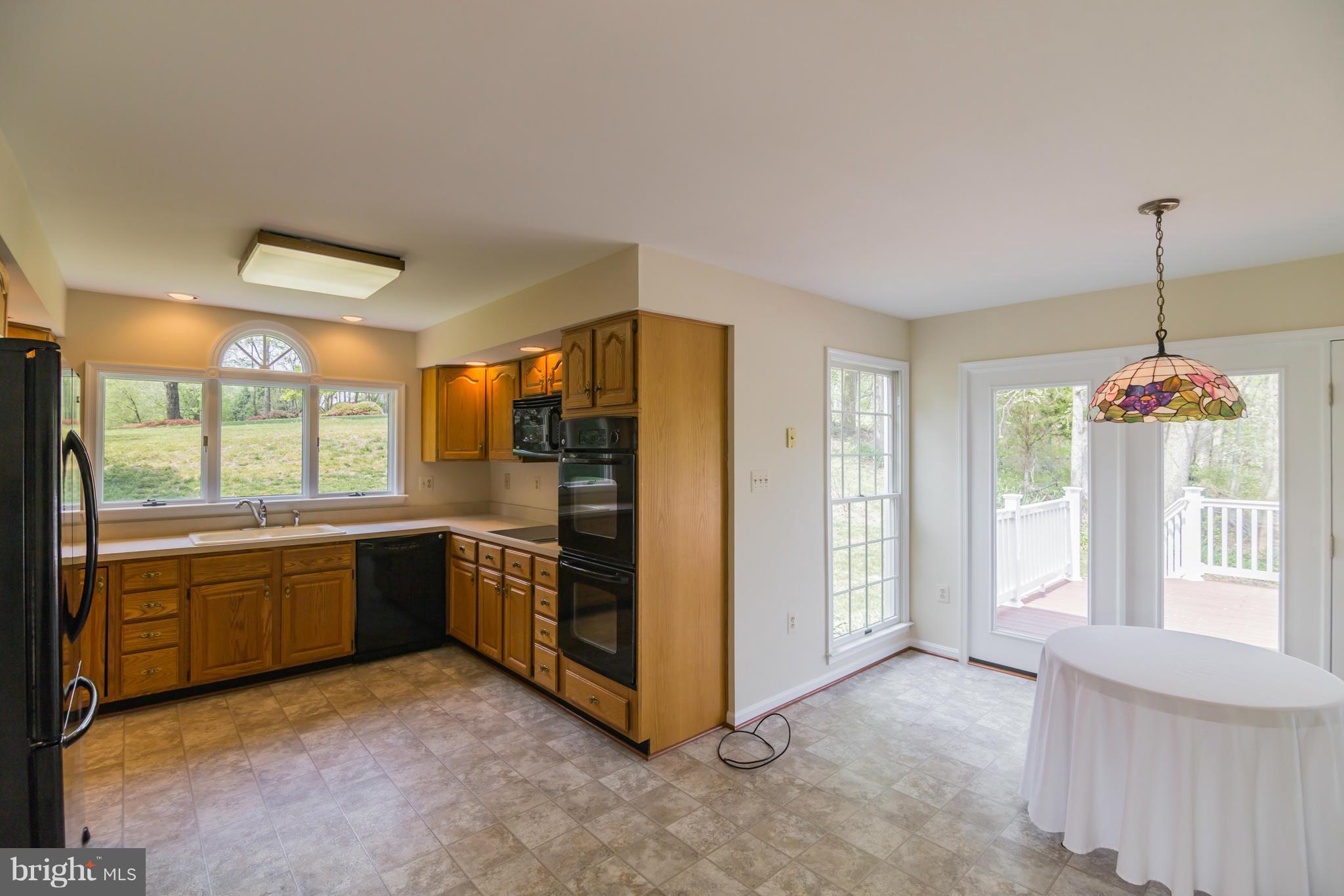3055 Hickory Ridge Road Dunkirk, MD 20754 - Photo 12 of 29 a kitchen with stainless steel appliances granite countertop a refrigerator and a sink