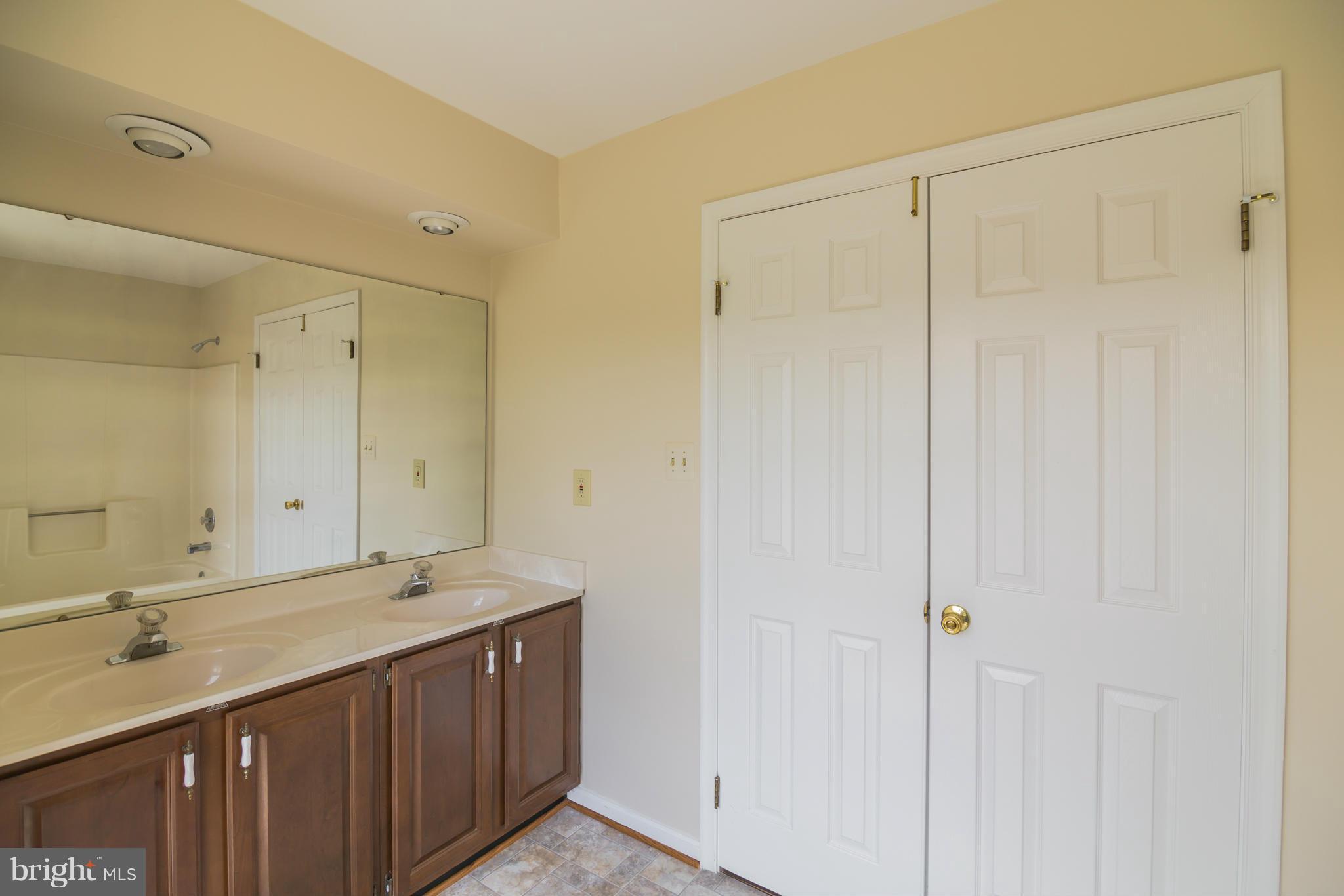 3055 Hickory Ridge Road Dunkirk, MD 20754 - Photo 22 of 29 a bathroom with a double vanity sink and a mirror