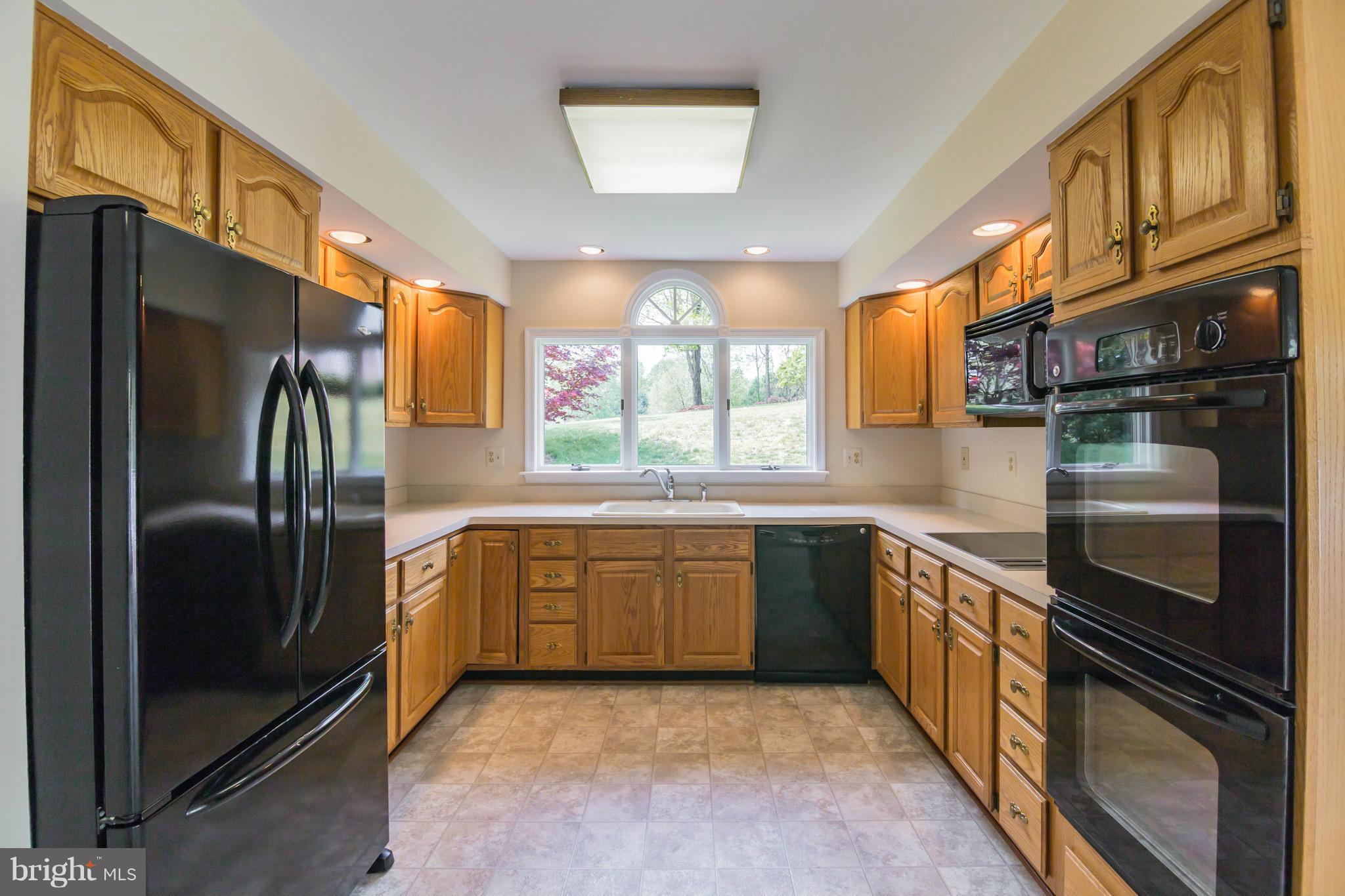 3055 Hickory Ridge Road Dunkirk, MD 20754 - Photo 4 of 29 a kitchen with stainless steel appliances granite countertop a refrigerator a stove and a sink