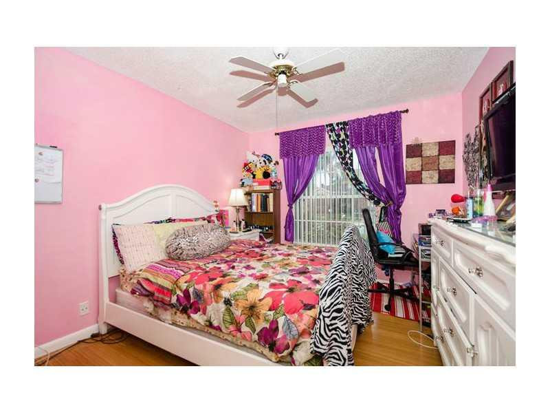 9406 Aegean Drive Boca Raton, FL 33496 - Photo 12 of 17 a bedroom with a bed and a table