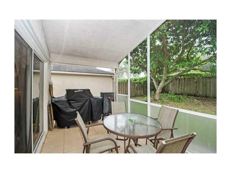 9406 Aegean Drive Boca Raton, FL 33496 - Photo 14 of 17 a balcony with table and chairs