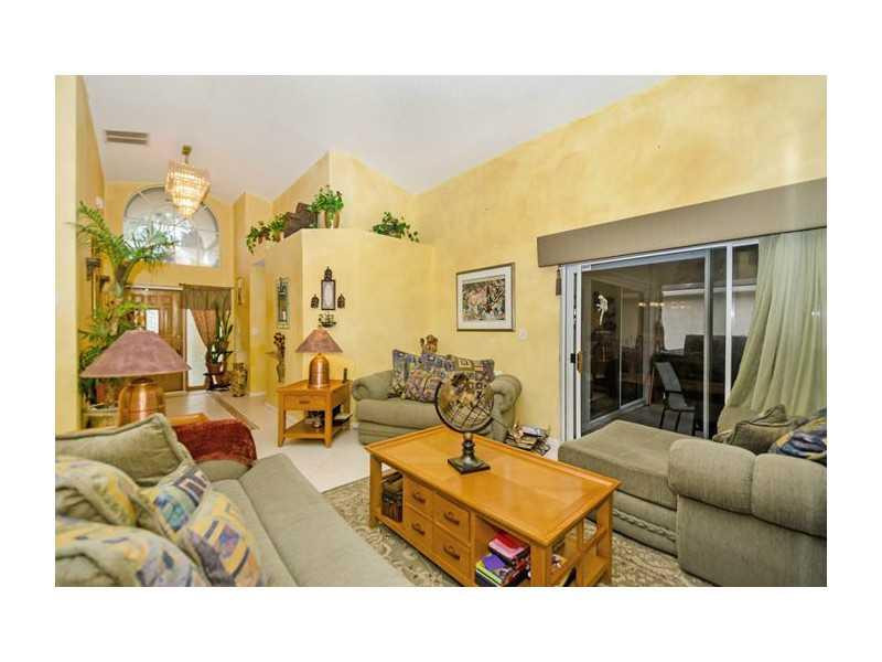 9406 Aegean Drive Boca Raton, FL 33496 - Photo 3 of 17 a room with furniture and a large window