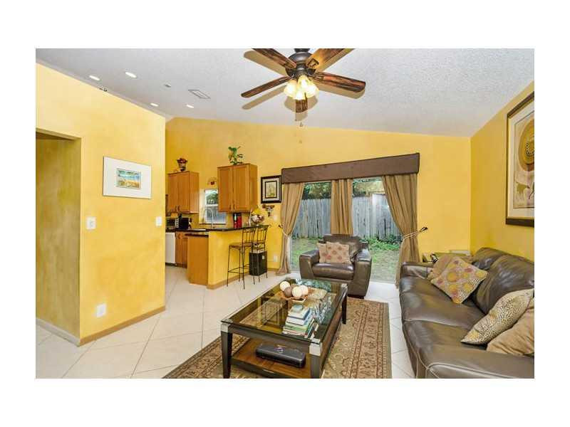 9406 Aegean Drive Boca Raton, FL 33496 - Photo 5 of 17 a living room with couches and painted walls next to a window