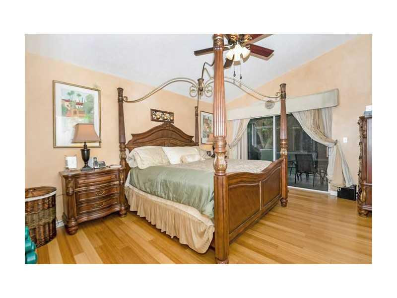 9406 Aegean Drive Boca Raton, FL 33496 - Photo 9 of 17 a bedroom with furniture and a wooden floor