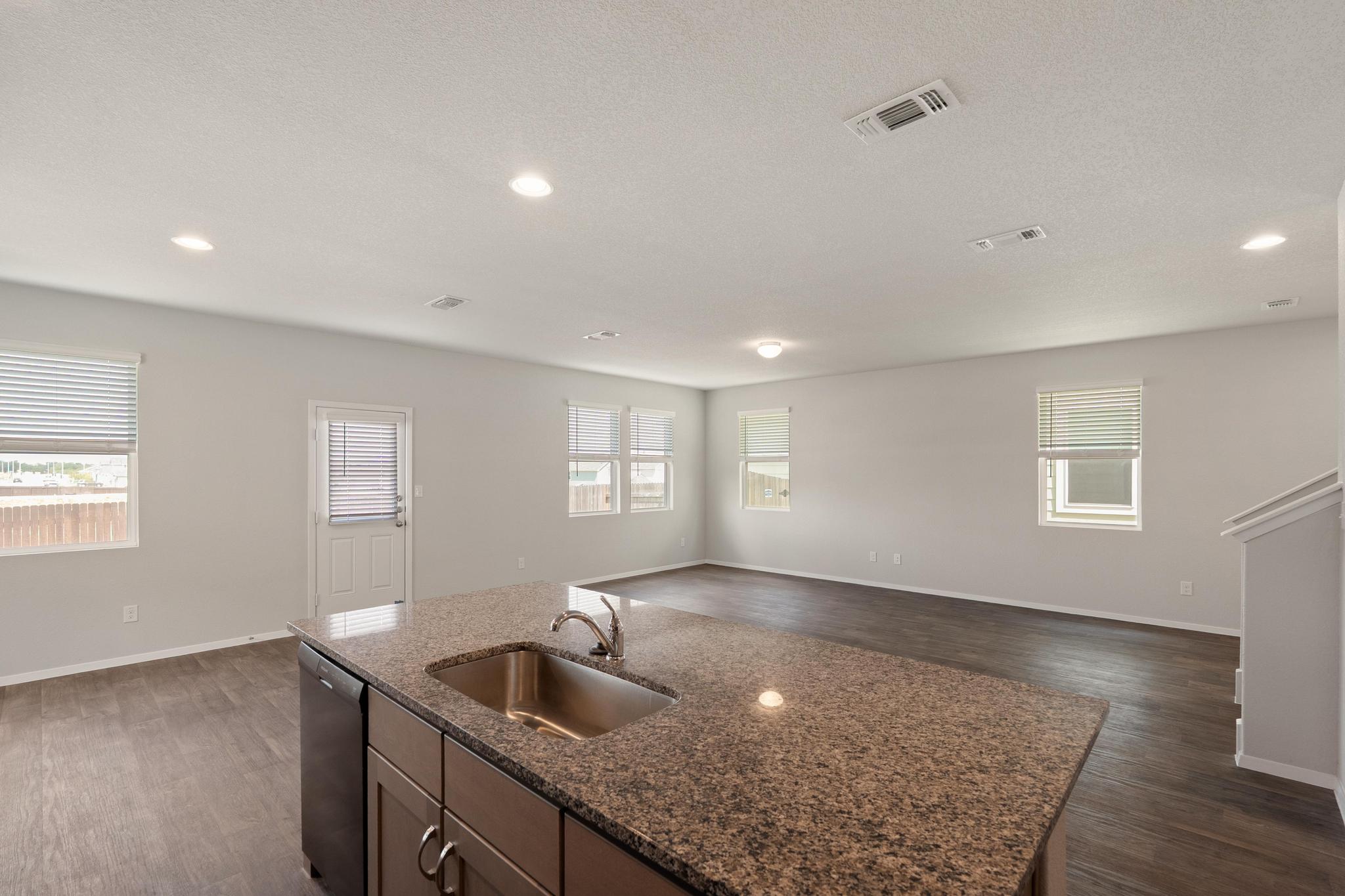 2812 Steels Road Manor, TX 78653 - Photo 6 of 25 Polished granite countertops anchor a seamless connection between the kitchen and main living area.