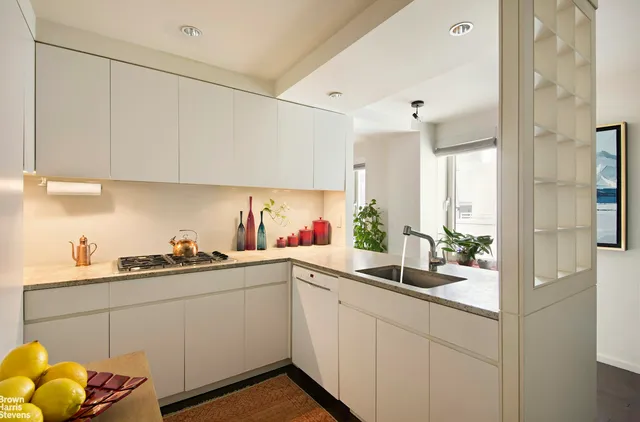a kitchen with a sink and cabinets