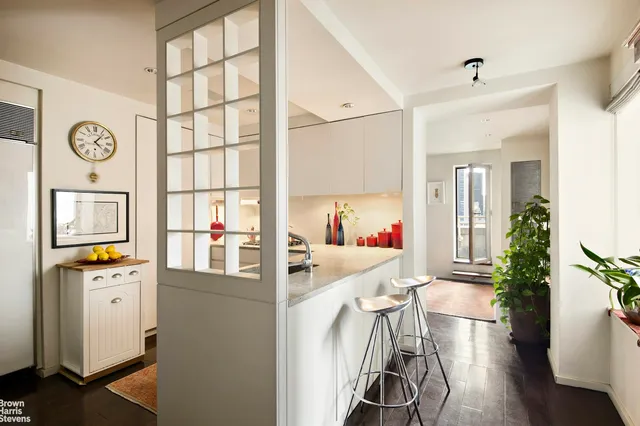 a view of kitchen with furniture and wooden floor