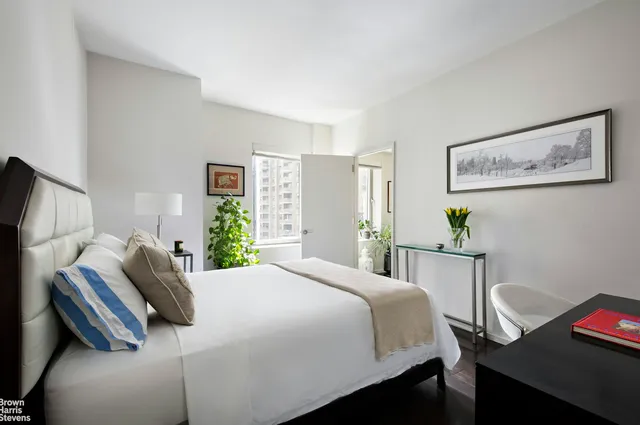 a bedroom with a bed and a desk