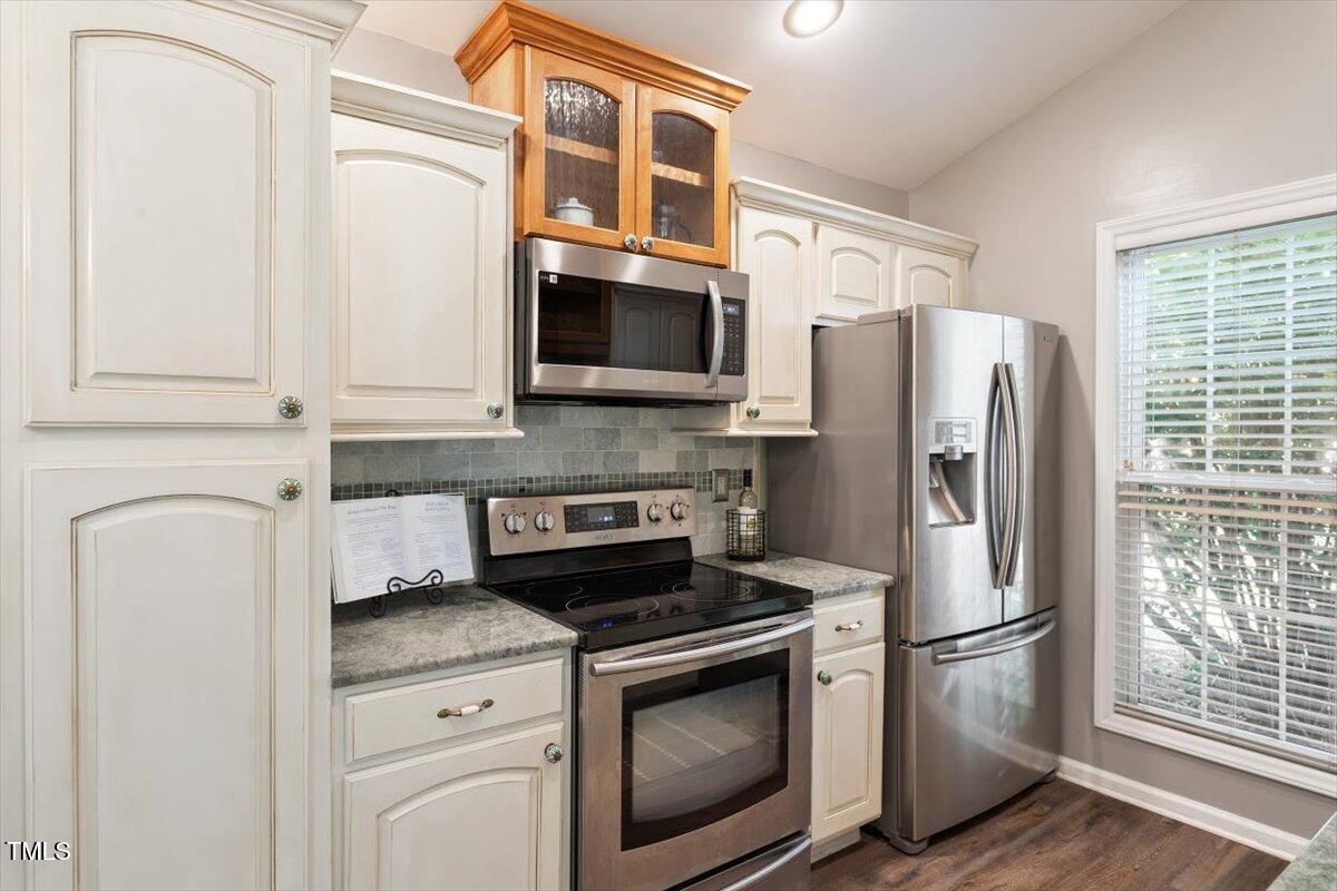 6412 Forest Ridge Drive Durham, NC 27713 - Photo 19 of 32 a kitchen with stainless steel appliances a refrigerator stove and microwave