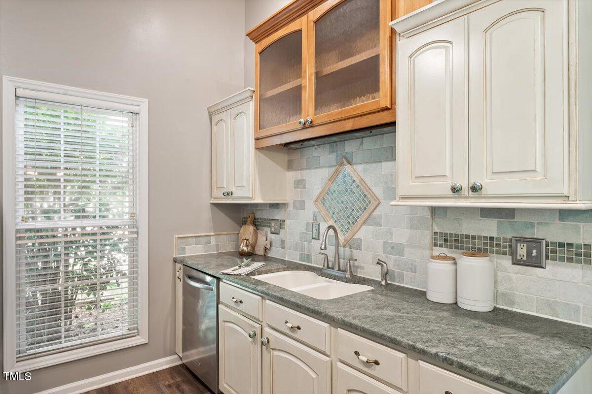 6412 Forest Ridge Drive Durham, NC 27713 - Photo 20 of 32 a kitchen with stainless steel appliances granite countertop a sink a stove and cabinets