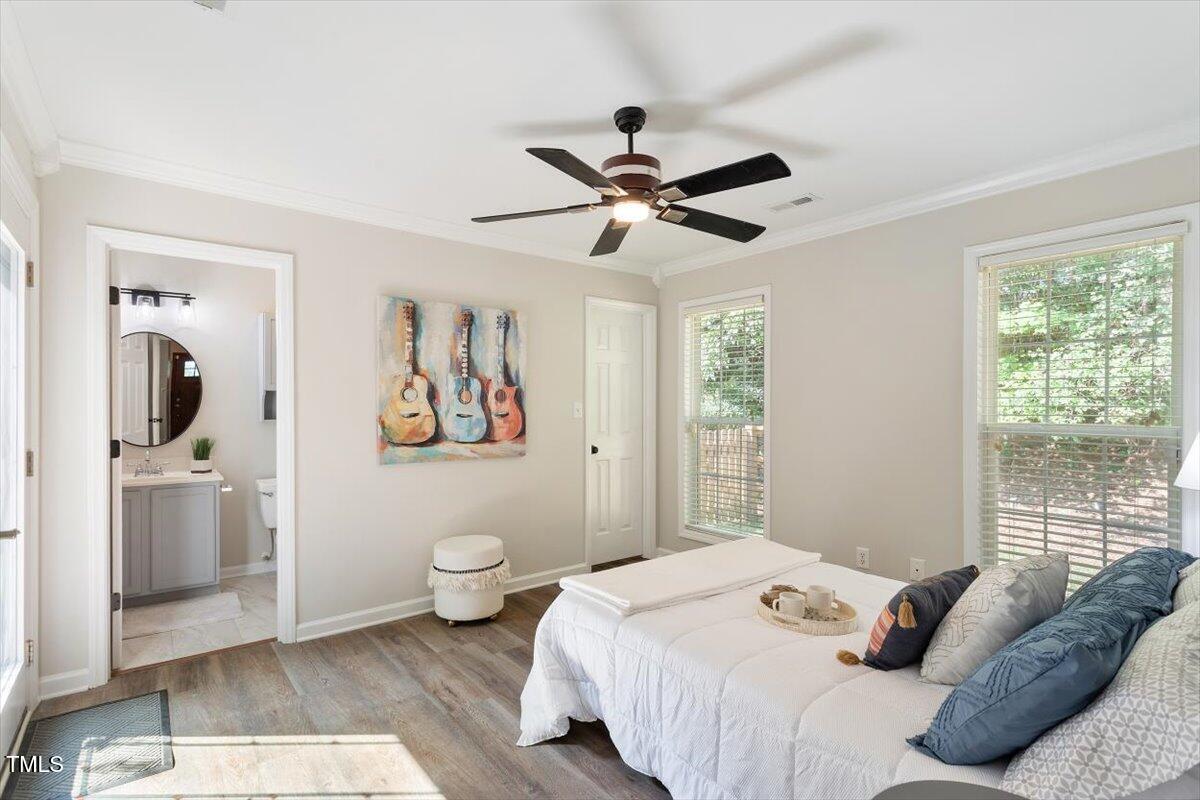 6412 Forest Ridge Drive Durham, NC 27713 - Photo 24 of 32 a bedroom with a bed and a window
