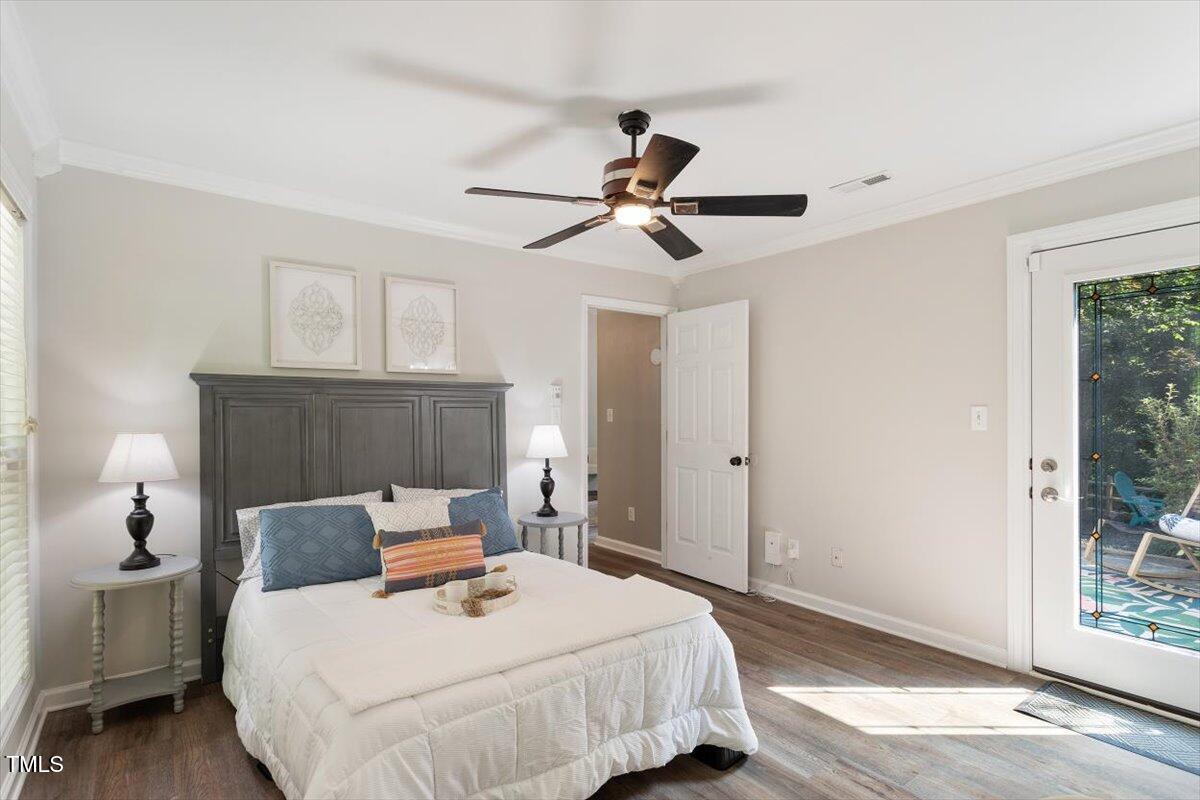 6412 Forest Ridge Drive Durham, NC 27713 - Photo 25 of 32 a bedroom with a bed and a chandelier