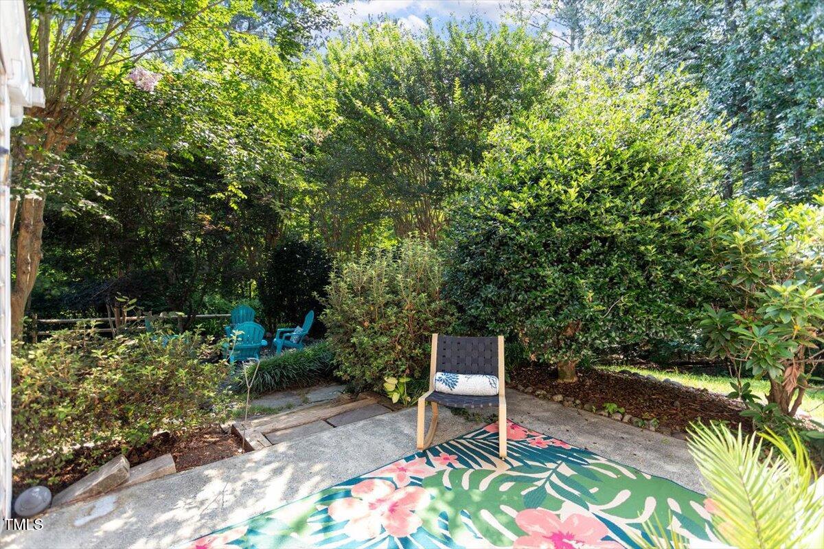 6412 Forest Ridge Drive Durham, NC 27713 - Photo 29 of 32 a bench sitting in the middle of a garden