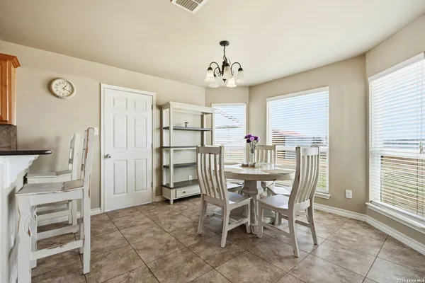 a kitchen with cabinets and chairs