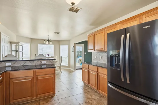 a kitchen with stainless steel appliances granite countertop wooden cabinets stove a sink and dishwasher