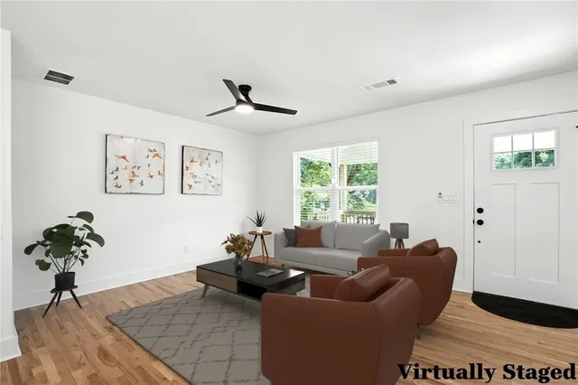 a living room with furniture potted plant and a window