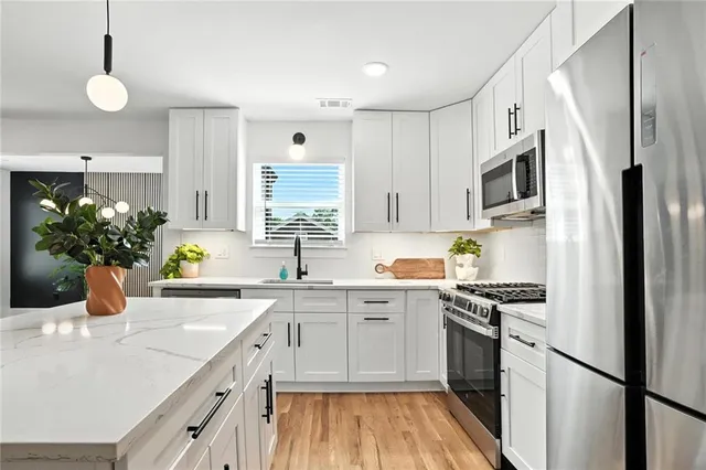 a kitchen with a sink stove and refrigerator