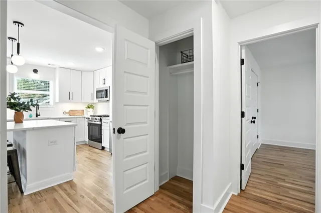 a view of kitchen with wooden floor and electronic appliances