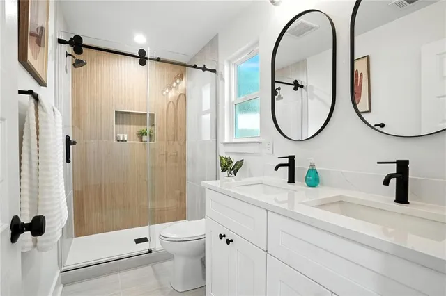 a bathroom with a sink a toilet and a mirror