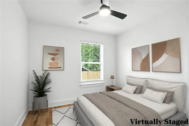 a bedroom with a bed and a potted plant