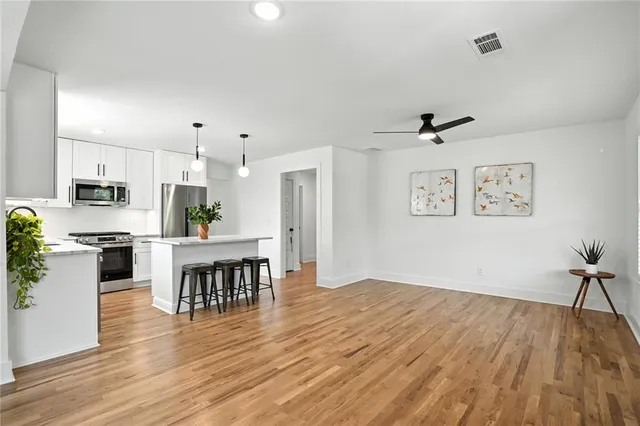 a open kitchen with white cabinets stainless steel appliances