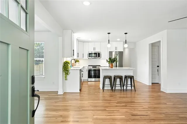 a view of dining room kitchen with stainless steel appliances kitchen island